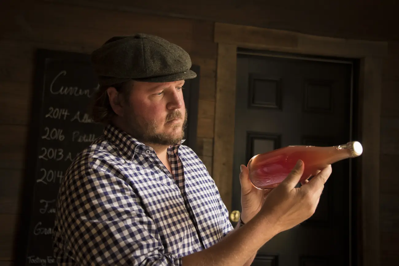 Garrett Bowlus with a bottle from the cellar