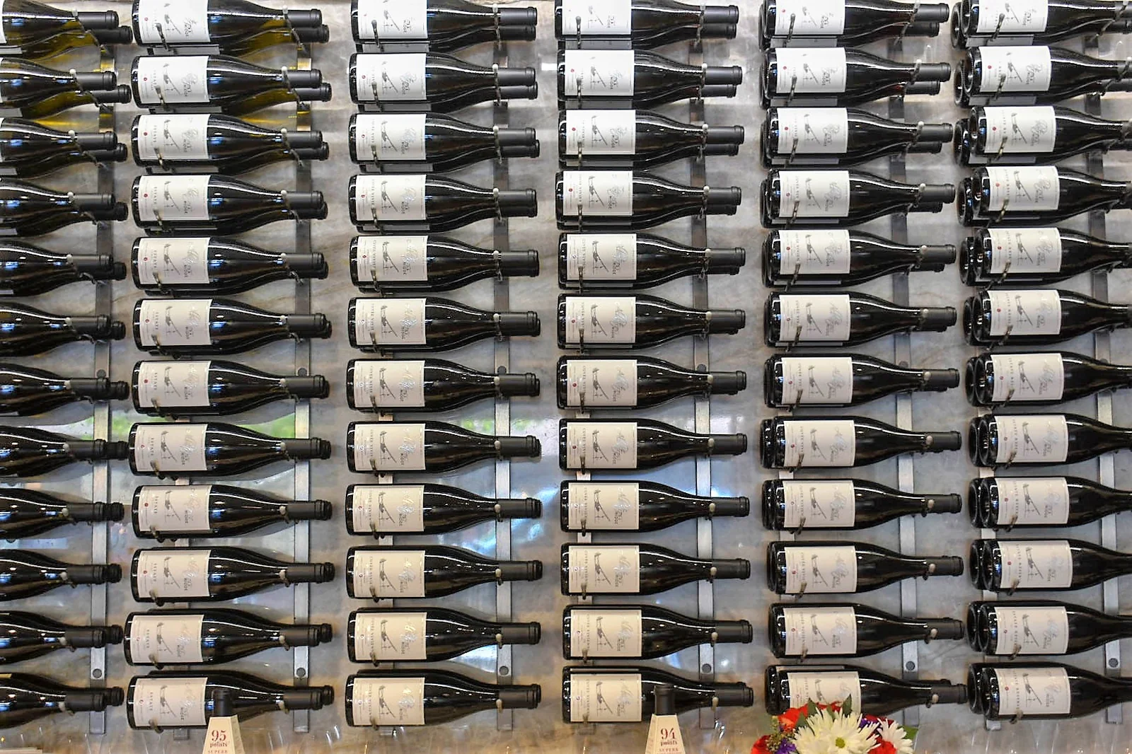 Estate bottles racked in the cellar, labels facing out