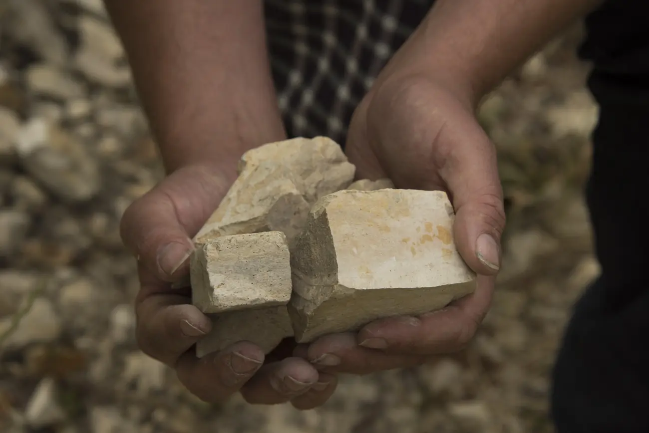 Garrett Bowlus holding a rock from the vineyard