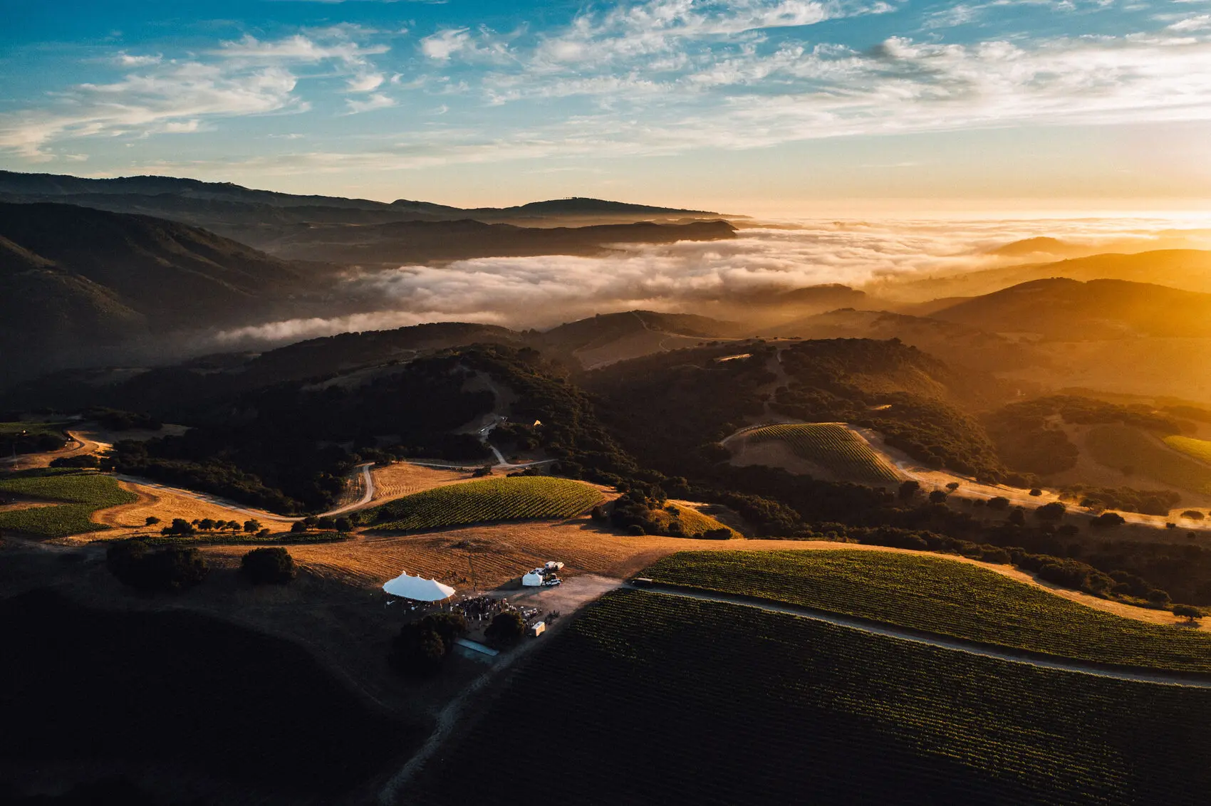 The Albatross Ridge estate from the air at sunset, fog filling the valleys below